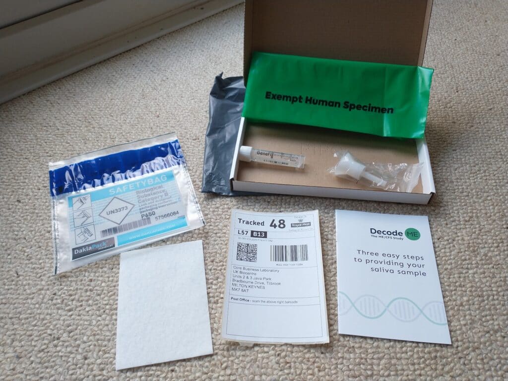 Spit kit with open boxed to show contents like funnel, plastic tube and bags.